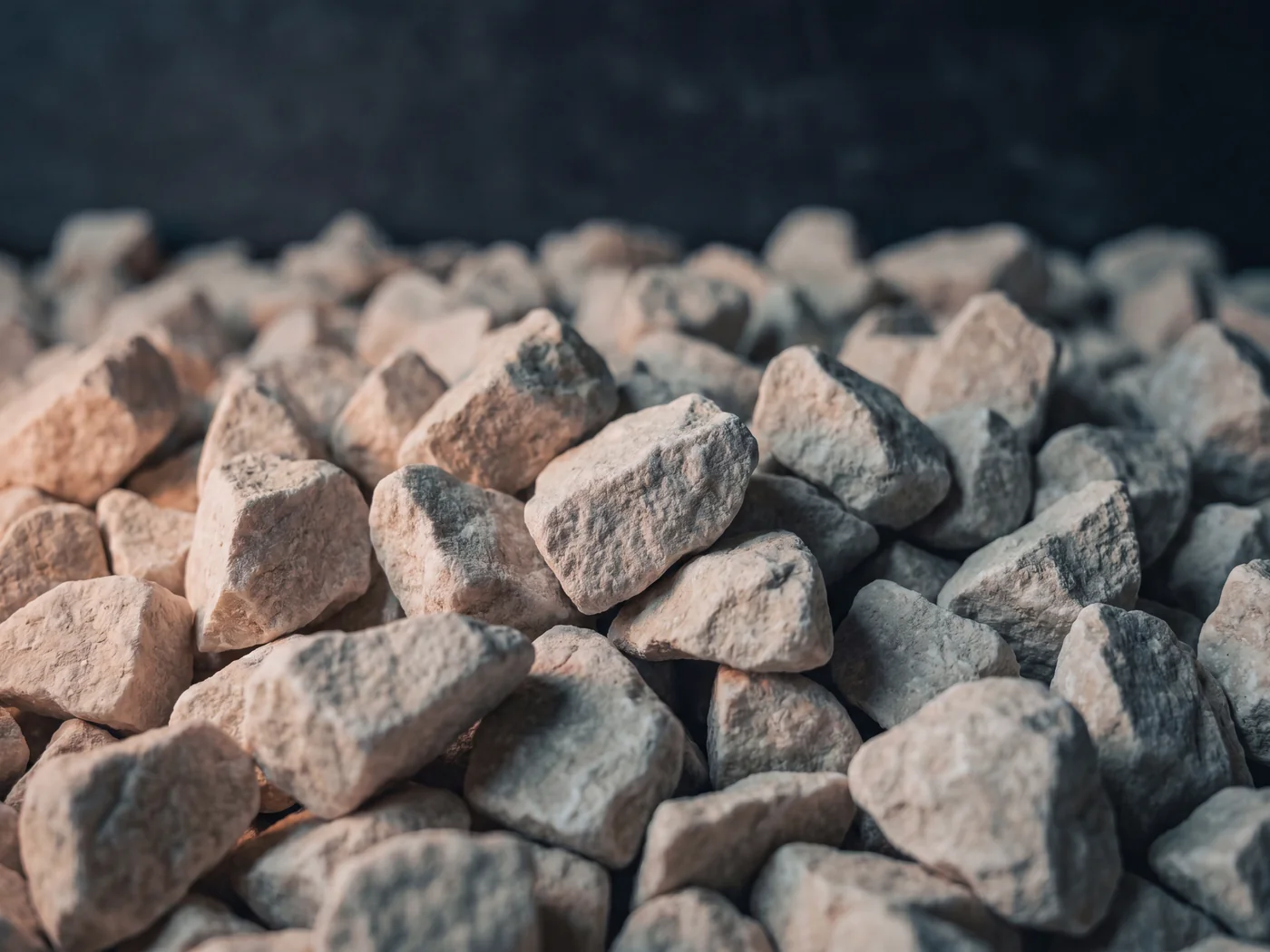 Close up of bright limestone chippings, pale angular stone for driveways and borders
